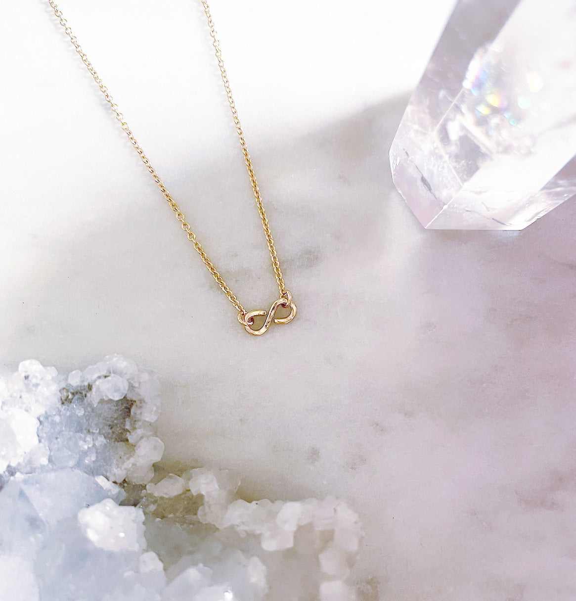 Dainty gold infinity necklace with a hammered infinity pendant in 14k gold filled