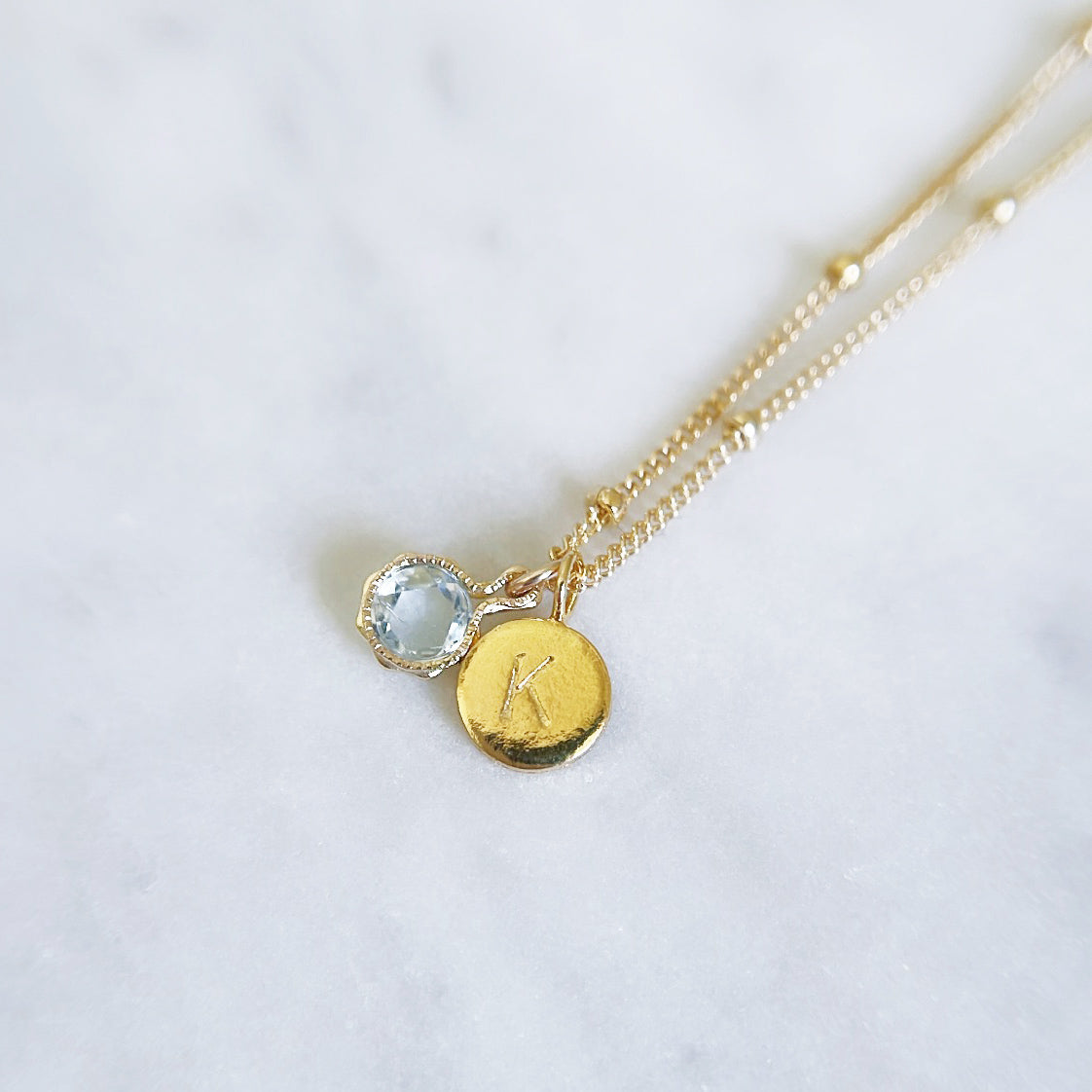March birthstone necklace with Aquamarine and gold initial pendant