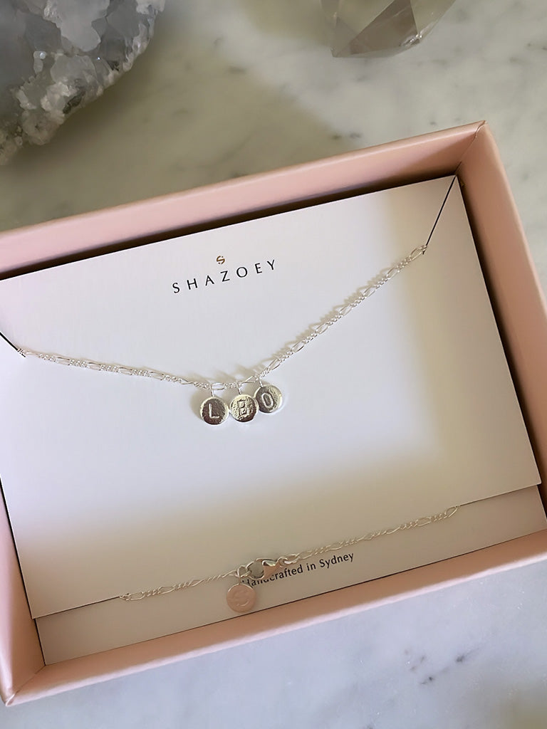 Personalised sterling silver necklace with initial pendants on a sterling silver figaro chain in gift box