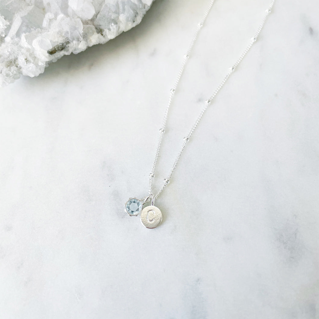 March birthstone necklace in sterling silver with a personalised initial and Aquamarine pendant