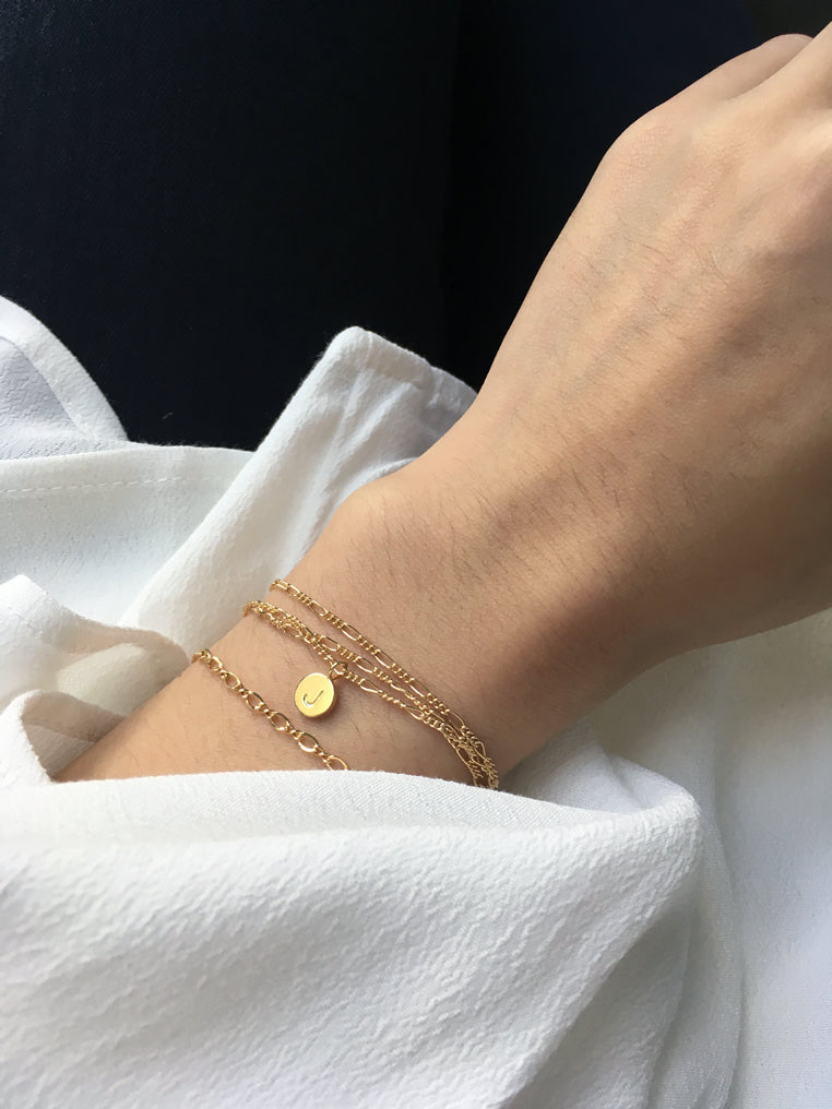 Dainty minimal gold bracelet stack with 14k gold filled figaro bracelet personalised with initial pendant and dainty gold round link chain
