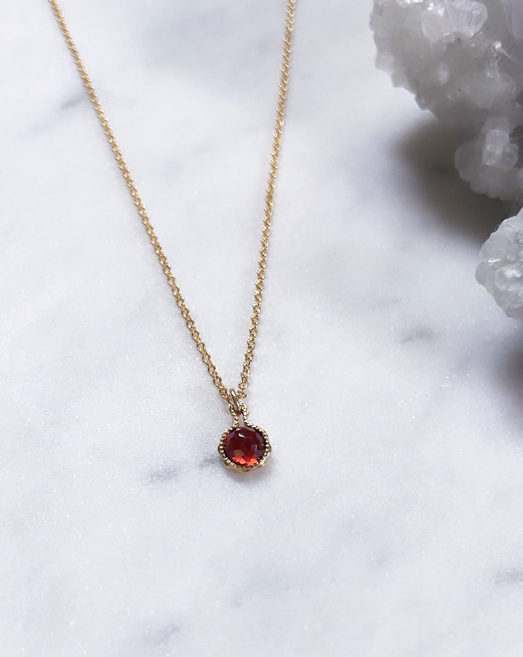 Dainty red garnet necklace for January in gold