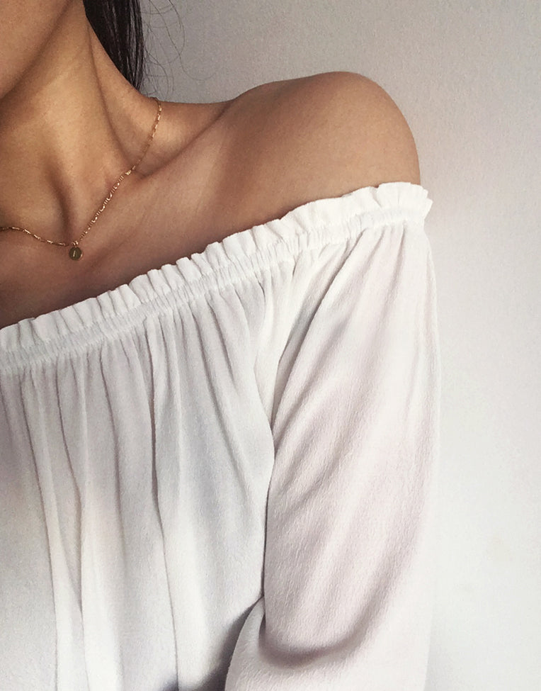 Custom gold initial personalised jewellery with figaro chain choker worn by model