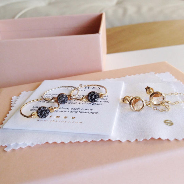 Dainty diamond rings and a pair of chain earrings for a bridal party by Australian jewellery brand
