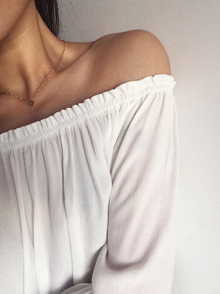 Personalised gold figaro necklace with custom initial pendant in 14k gold filled worn by model