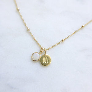 An Australian opal necklace with a gold satellite chain personalised with a gold M initial pendant