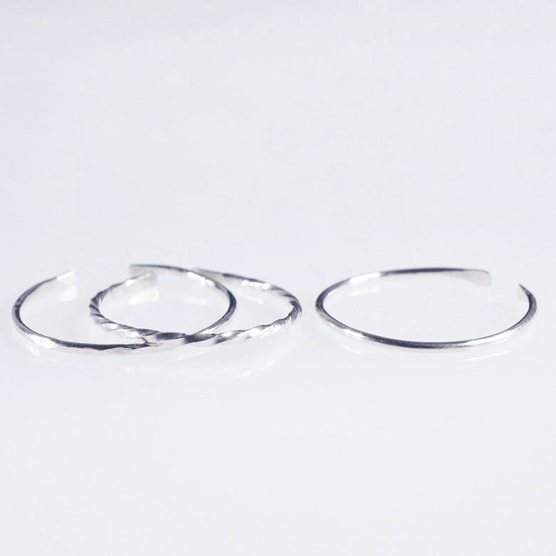 A set of 3 Sterling silver plain, hammered and twisted bands