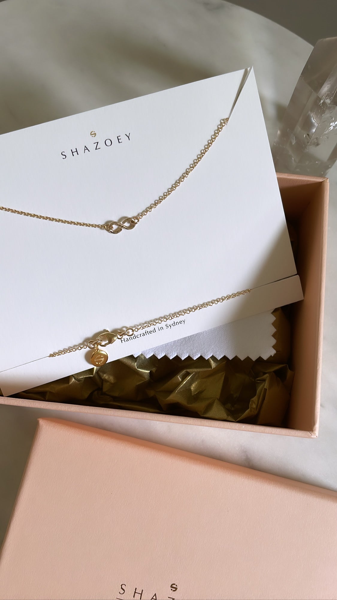 Australian handmade gold infinity necklace with a fine gold chain presented in luxury gift packaging