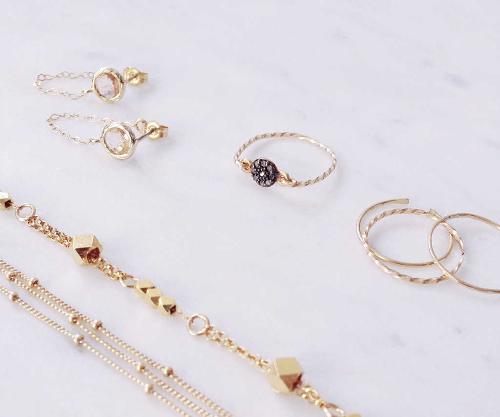 Gold minimalist jewellery handmade in Sydney Australia showing dainty gold stacking rings, gold chains and bracelets.