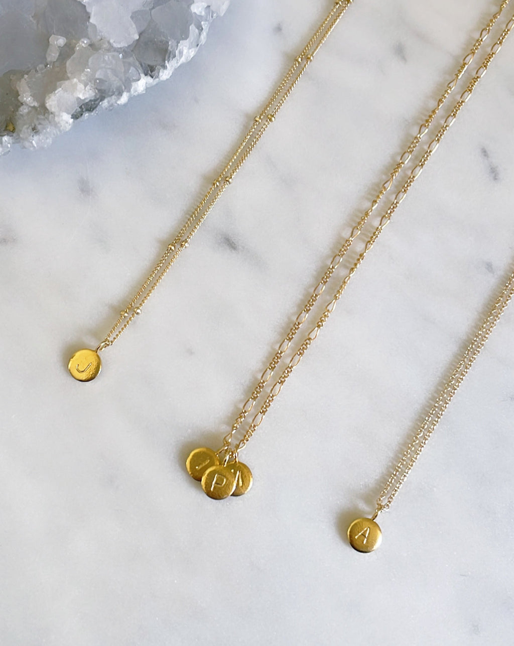 Personalised gold initial necklaces with custom letter charms on 14k gold filled figaro and cable chains