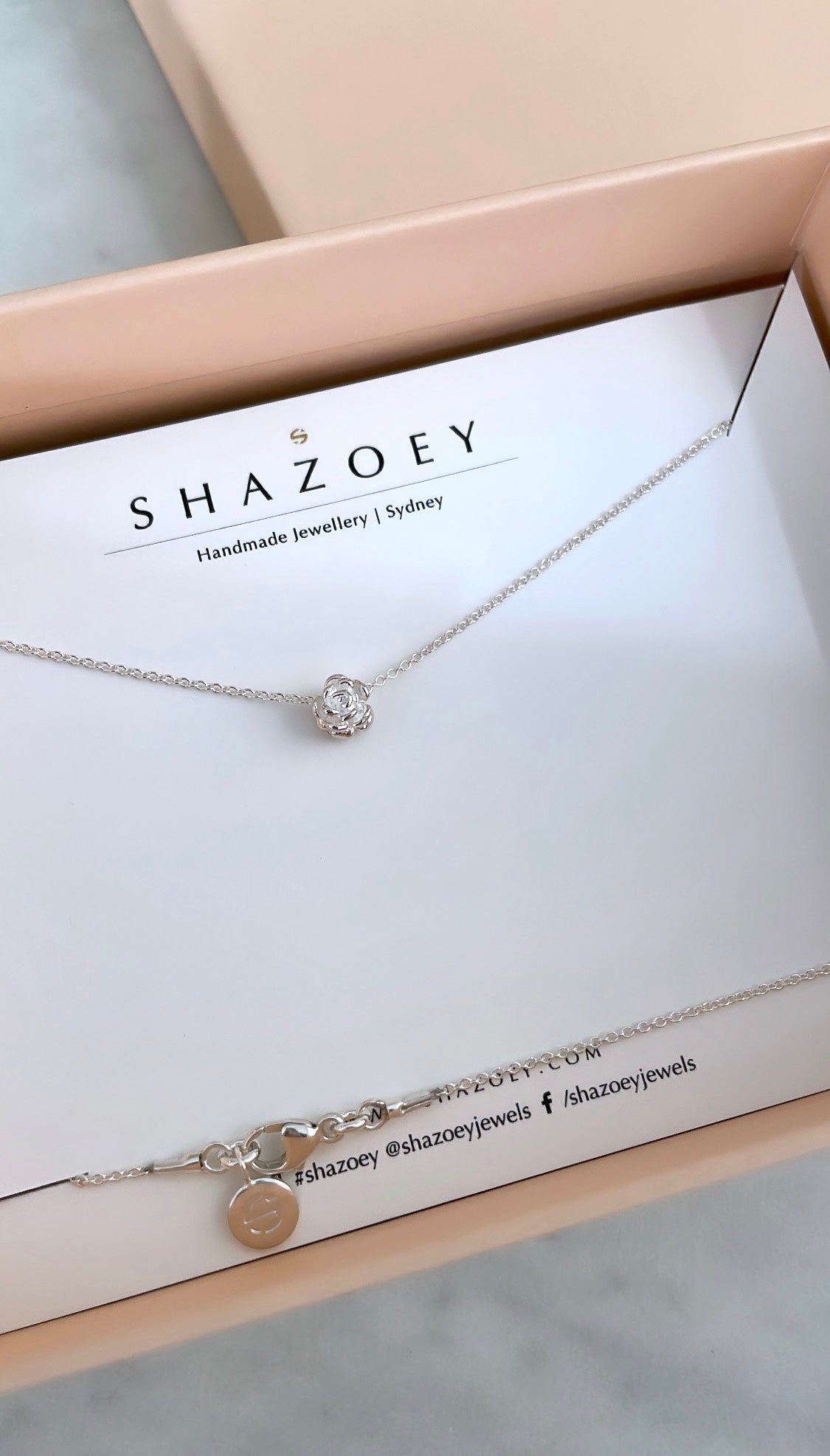 Silver flower pendant necklace on a Shazoey branded card and in gift box