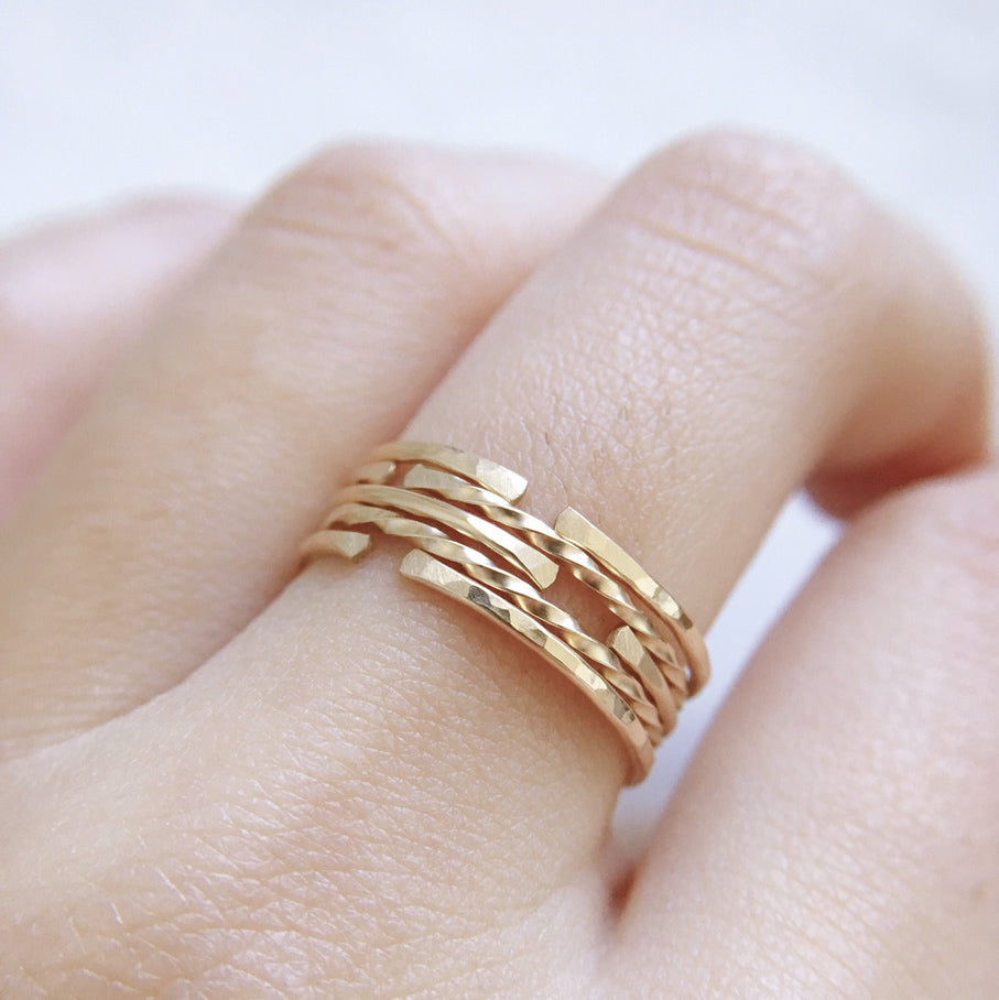 Thin gold stacking ring bands worn together as a ring stack