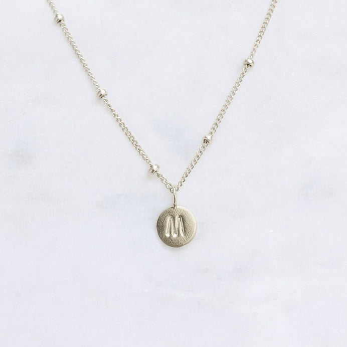 Personalised sterling silver initial necklace with custom letter pendant on a minimalist sterling silver dot chain