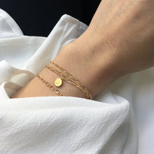 Dainty gold bracelet personalised with a letter charm pendant and a minimalist gold bracelet
