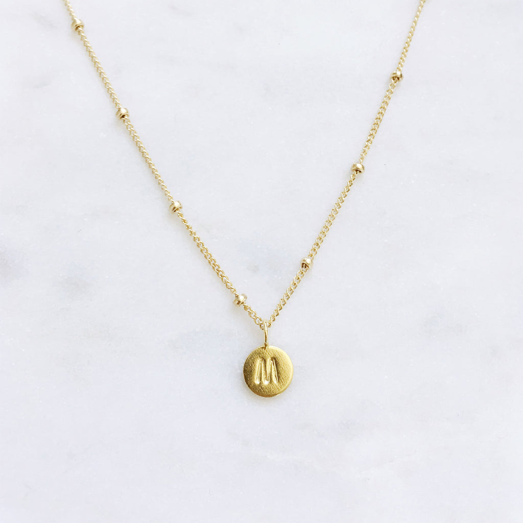 Personalised gold initial necklace with a hand stamped letter on a minimalist 14k gold filled chain, handmade in Australia