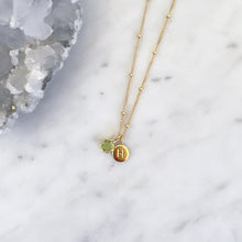Gold peridot necklace with an initial pendant and fine gold chain