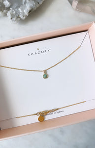 A Gold Australian turquoise pendant necklace in its pink gift box by the brand "SHAZOEY"