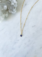 Round Blue sapphire necklace on a gold chain