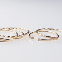A set of 5 gold filled open ring bands with a classic, hammered and twisted finish