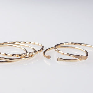 A set of 5 gold filled open ring bands with a classic, hammered and twisted finish