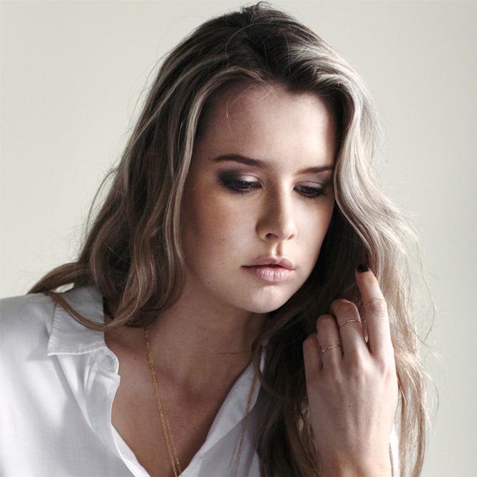 Rose gold thin rings worn as a stack or midi rings as shown by our model