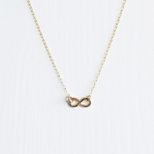 A simple minimal 14K gold infinity necklace