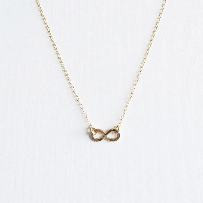 A simple minimal 14K gold infinity necklace