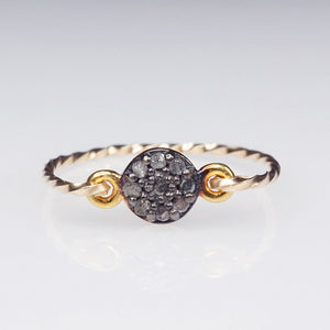 A pavé rough diamond ring featuring 9 tiny diamonds on an oxidised setting with a gold filled twisted band 