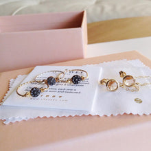 3 gold pavé rough diamond rings and a pair of glass chain stud earrings for a bridal party
