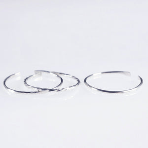 A set of 3 Sterling silver plain, hammered and twisted bands 